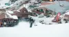 A snow bike rider goes airborne at the base of Red River Ski Area during Race the Face.