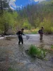Two anglers fly fish in the shallow waters of the Red River in New Mexico.