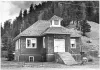 The Little Red School House in Red River in a black-and-white photograph from about 1980.