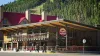 The Red River Brewing Company building and patio on West Main Street, with the ski slopes rising behind it.