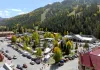 An aerial view of Oktoberfest crowds in Brandenburg Park beneath Red River's ski slopes and golden aspens.