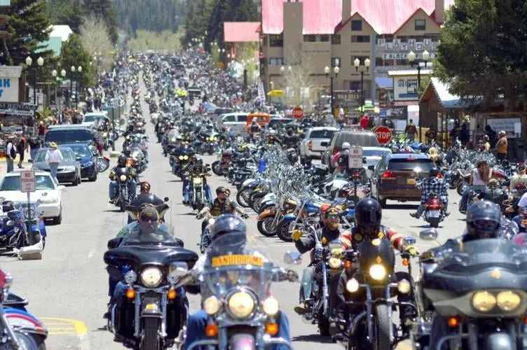 The Memorial Day Motorcycle Rally fills Main Street in Red River with bikes and flags.