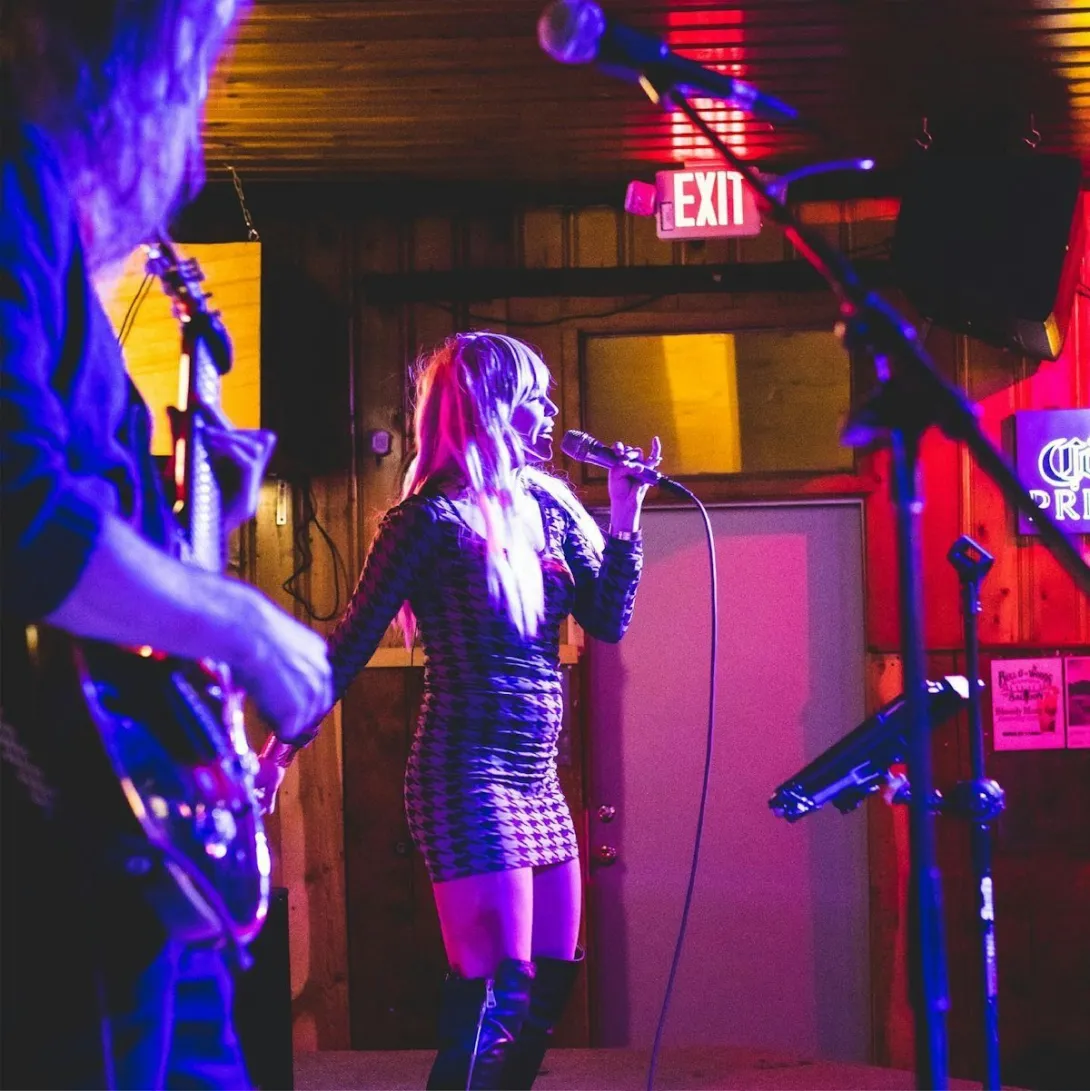 A live band performs on stage at a Red River venue during the Red River Jamboree.