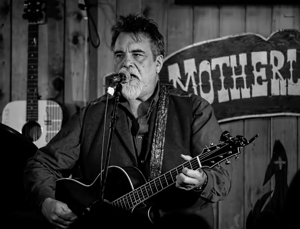 Darrell Scott performs with his guitar at the Motherlode Saloon during the Red River Songwriters' Festival.