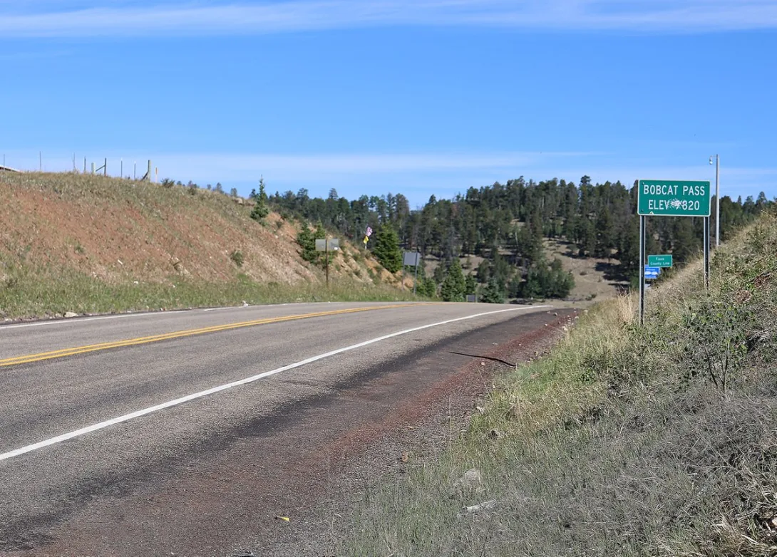 The Bobcat Pass summit sign on NM-38 at 9,820 feet on the Continental Divide above Red River.