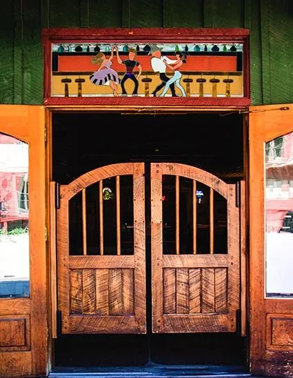 The swinging wooden doors of the Bull O' the Woods Saloon on Main Street in Red River.